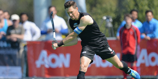 Simon Child passes the ball for the Black Sticks against India. Photo / Getty Images