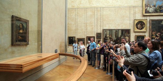 Tourists crowd around da Vinci’s Mona Lisa at the Louvre museum, Paris. Photo / 123RF