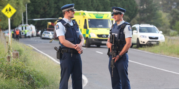 Armed police at the road block on Onepu Spring Rd. Photo / Alan Gisbon