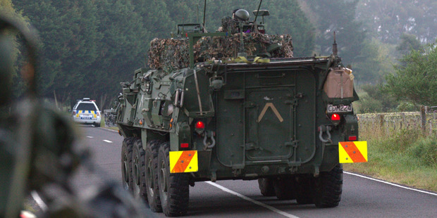 Heavily armed police on Onepu Springs road, just out from Kawerau as the siege continues. Photo / Nick Reed
