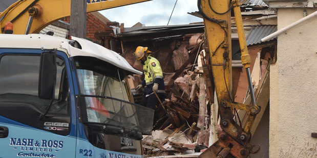 Firefighters look to stabilise a partly demolished building in Frederick St. Photo: Gregor Richardson/Otago Daily Times