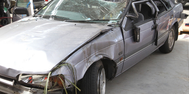 Police examine a car after a fatal accident on SH2. Photo / Duncan Brown