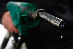 Unleaded fuel drips from a petrol pump. Photo / Bloomberg