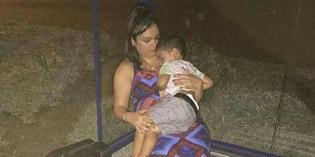 Aileen Chand with her young boy at a bus stop after she was refused on board a Tiger Airways flight. Photo / Facebook