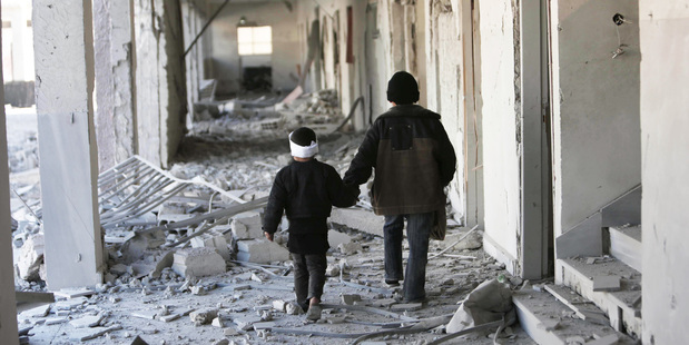 Loading Two children walk through the corridors of a destroyed school in Eastern Ghouta, Syria. Photo / Save the Children, via AP