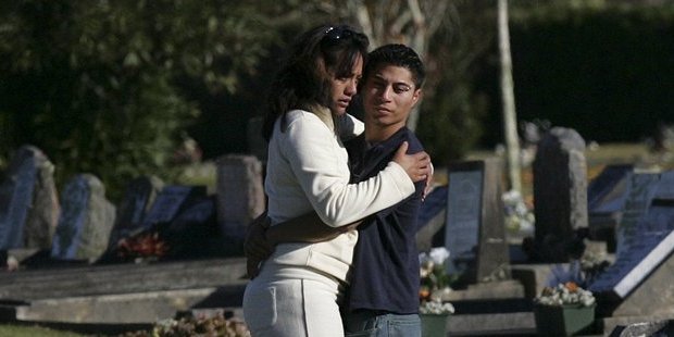 The parents of the twin Kahui babies gather at the grave at Mangere Lawn Cemetery. Photo / Janna Dixon