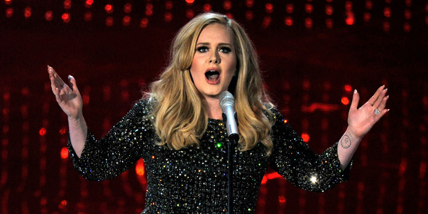 Adele cried after two fans got engaged at her concert.