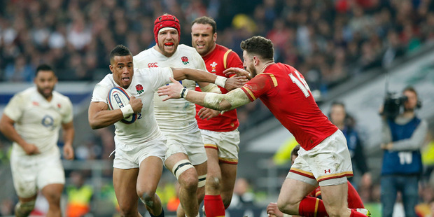 England's Anthony Watson, left, tries to get past Wales' Alex Cuthbert during the Six Nations international rugby match between England and Wales. Photo / AP
