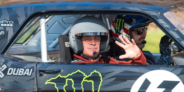 Actor and Top Gear presenter Matt LeBlanc waves as he sits with rally driver Ken Block during the filming of BBC Top Gear in Westminster, London. Photo / AP