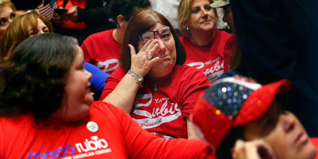 A supporter of Republican presidential candidate Marco Rubio wipes a tear during a Republican primary night celebration rally at Florida International University. Photo / AP