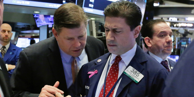 Traders Edward Schreier, left, and Anthony Carannante confer on the floor of the New York Stock Exchange. Photo / AP