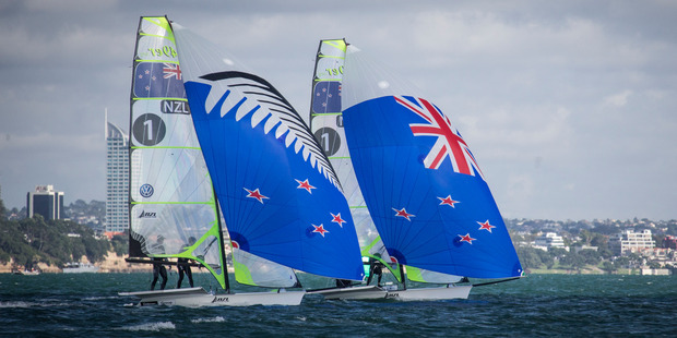New Zealand 49er sailors Peter Burling and Blair Tuke show off the flag options. Photo / Greg Bowker