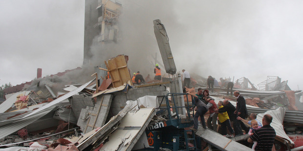 Rescuers search for survivors on top of rubble at the CTV site. Photo / Geoff Sloan