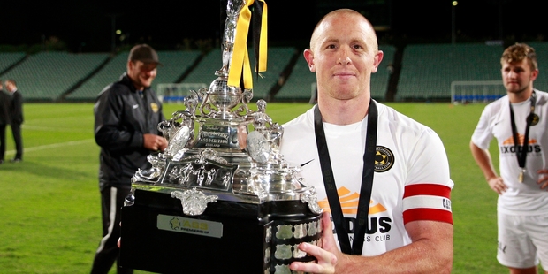 Wellington's Bill Robertson holds the ASB Premiership trophy aloft. Photo / Photosport