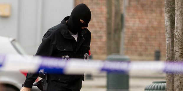 Police secure an area in Brussels during an anti-terror raid linked to last year's Paris attacks. Photo / AP
