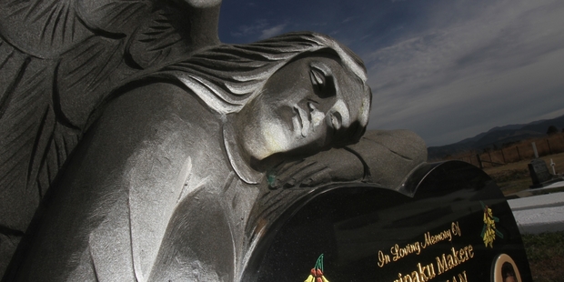 A carved angel rests upon a headstone at Te Uru O Tane (Black Bridge) urupa. PHOTO/ANDREW BONALLACK