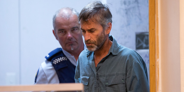 Brendan Paul Henson is led into the dock at Palmerston North District Court. Photo / Mark Mitchell