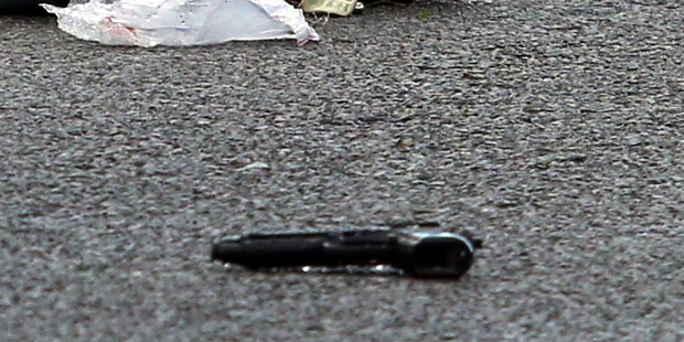 Gun on the street at the scene of the shooting. Photo / Stu Munro