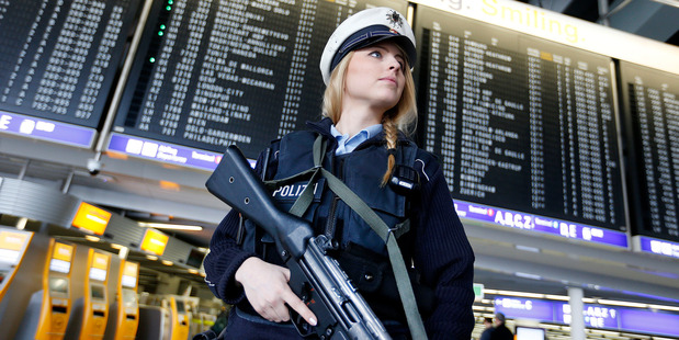 A German police officer guards a terminal of the airport in Frankfurt, Germany after two explosions hit the Belgian capital Brussels. AP photo / Michael Probst