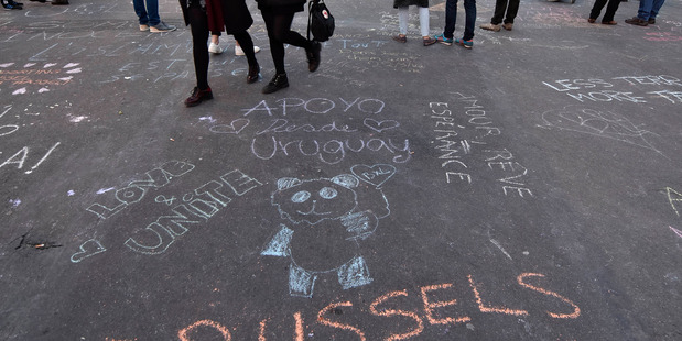 Writing at the place de la Bourse in the centre of Brussels, where people are remembering the victims. Photo / AP
