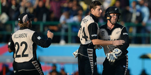 Luke Ronchi celebrates with spinner Mitchell Santner and skipper Kane Williamson. Photo / Getty