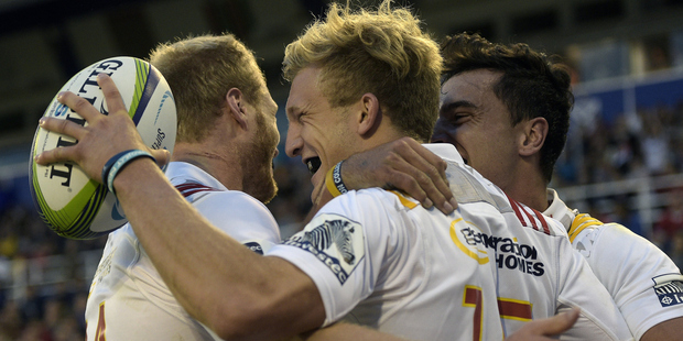 Damian McKenzie celebrates with Sam McNicol and James Lowe after scoring. Photo / Getty