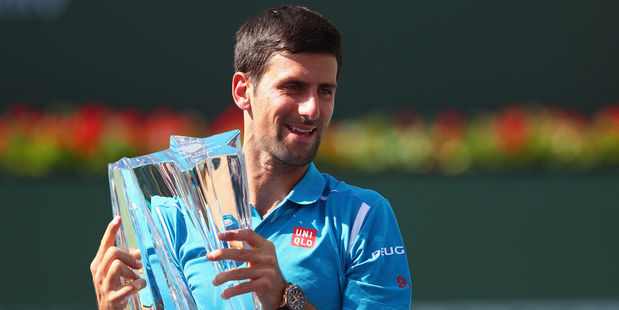 Novak Djokovic holds up the trophy after his win over Milos Raonic at Indian Wells. Photo / Getty Images