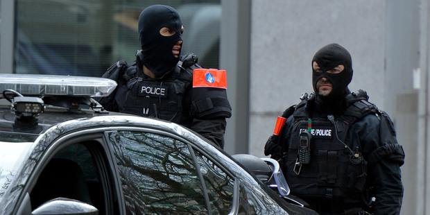 Police officers stand guard around the Maalbeek Metro station following a blast at the station in Brussels. Photo / Getty Images
