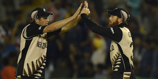 Mitchell Santner celebrates with Martin Guptill during the Black Caps' win over Pakistan. Photo / Getty