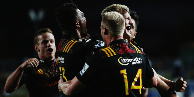 Damian McKenzie celebrates after finishing off a superb team try. Photo / Getty