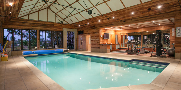 The separate pool house has an indoor swimming pool, gymnasium, sauna, kitchen and bathroom. Photo / Jason Tregurtha