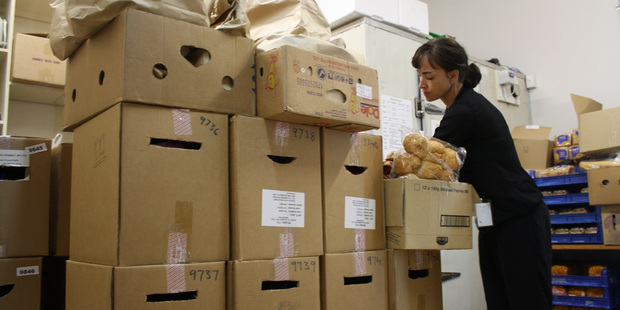 An Auckland City Mission volunteer packs family food parcels. Photo / Supplied