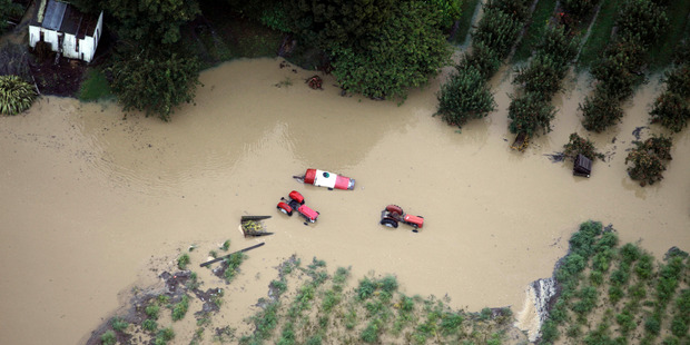 Aerial view of tractors trapped in flooding near Riwaka, Nelson. Photo / Tim Cuff
