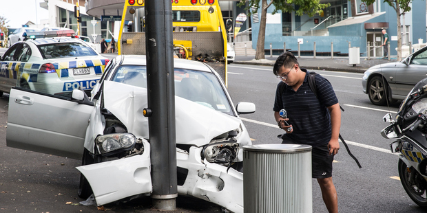 The drama unfolded about 11am when a white car turned left onto Queen St from the Symonds St end of Karangahape Rd. Photo / Michael Craig
