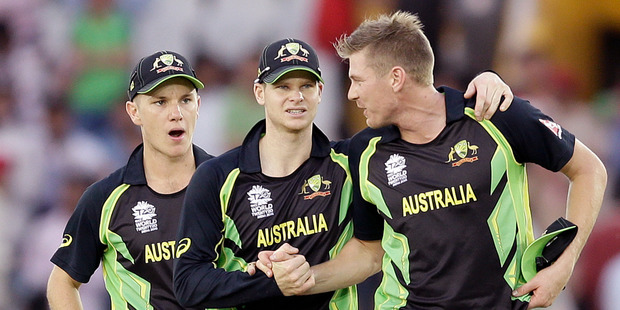 Australia's captain Steven Smith, centre, and Adam Zampa, left, congratulate bowler James Faulkner, right, after he took five wickets in their 21 run win over Pakistan. Photo / AP.