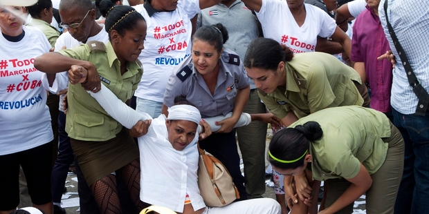 Police dragged away members of Ladies in White, a women's dissident group that calls for the release of political prisoners. Photo / AP