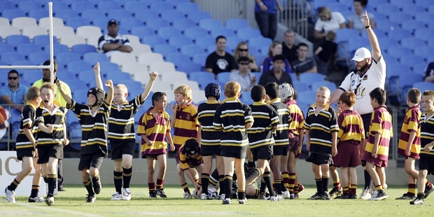 Age-group players at the end of a Super Rugby curtain-raiser at Eden Park. The big attraction has been part of the problem. Photo / Photosport