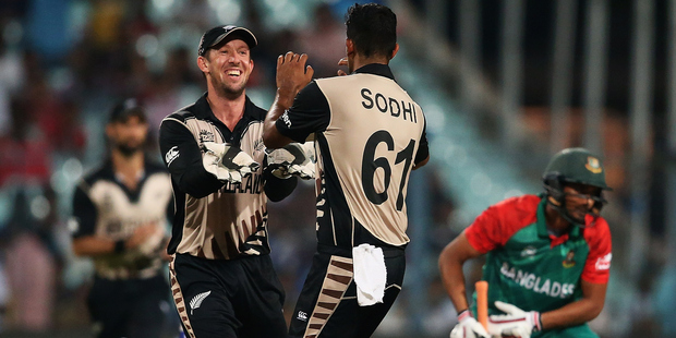 Luke Ronchi congratulates Black Caps bowler Ish Sodhi after he bowled Mahmudullah of Bangladesh. Photo/Getty.