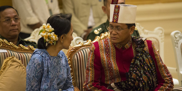 Myanmar's new Foreign minister Aung San Suu Kyi chats with Vice president Henry Van Thio as they attend the ceremony to handover the country's presidency. Photo / Getty Images