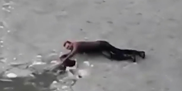 The man and his dog had perhaps attempted to cross over the frozen lake, underestimating the thickness of the ice. Photo / Supplied via Live Leak