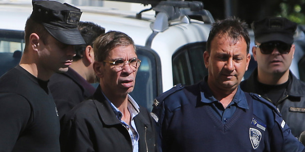 The EgyptAir plane hijacking suspect is escorted by Cyprus police officers as he leaves a court. Photo / AP
