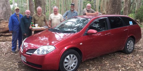 The Kerikeri Woodchoppers with the car donated to Finkk founder Monika Welch so she can continue with her charity work, and the St Patrick's Day morning tea she made them as thanks. PHOTO / SUPPLIED