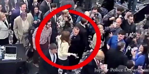 The moment Donald Trump's campaign manager grabs a reporter by the arm and pulls her away from Trump. Photo / Jupiter Police Department