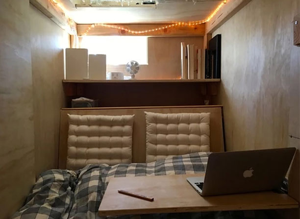 Its exterior resembles a large crate, while its inside houses a twin bed, a fold-up desk and some LEDs. Photo / Peter Berkowitz