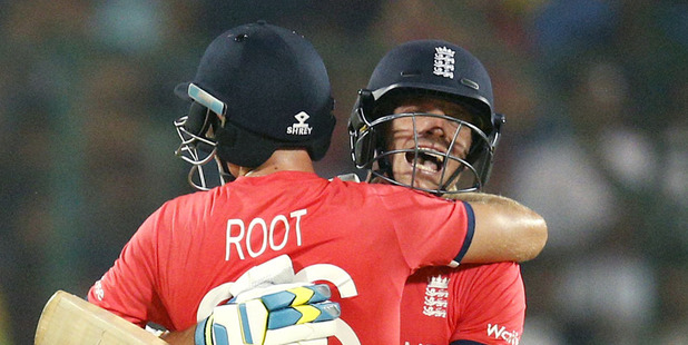 England's Jos Buttler, right, embraces teammate Joe Root after defeating New Zealand. Photo / AP