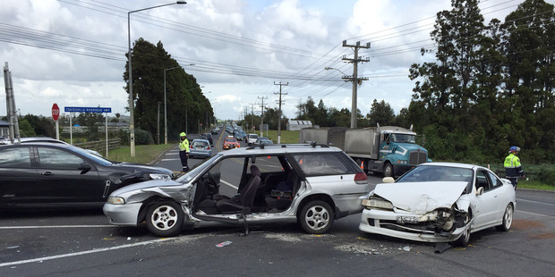 The scene of a three car crash at the intersection of State Highway 16 and the Coatseville-Riverhead Highway. Photo / Brett Phibbs