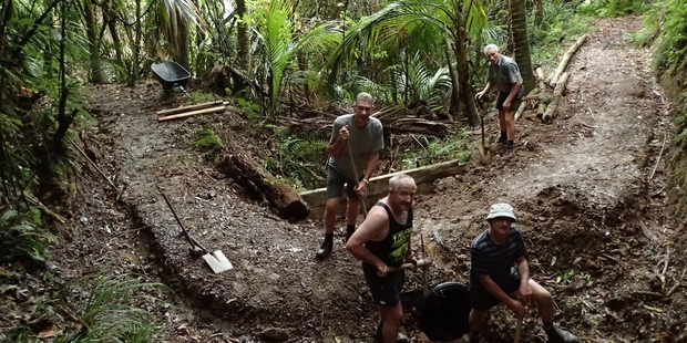 Tony Palmer, Dave Pask, Mike Stuart and Peter Margerison think nothing of giving their weekends to the construction of a dual-use mountain biking and tramping track. Photo / Jim Robinson