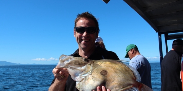 Lee Small scored a bonus when a large john dory took his bait. Photo / Geoff Thomas