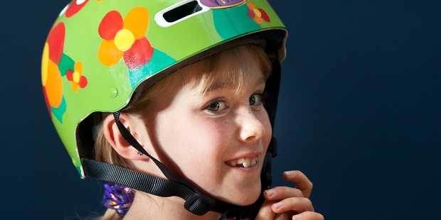 FLOWER POWER: Mia Olsen, 8, one of the Travel Safe Design your Own Helmet competition winners, models her helmet. PHOTO/ANDREW WARNER