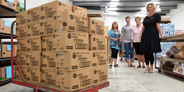 Tauranga Community Foodbank manager Nicki Goodwin, Guide biscuit champion Donna Lendrum, Girl Guiding organisation member Janet Reekie and Legacy funeral director Annie Innes with the biscuits.